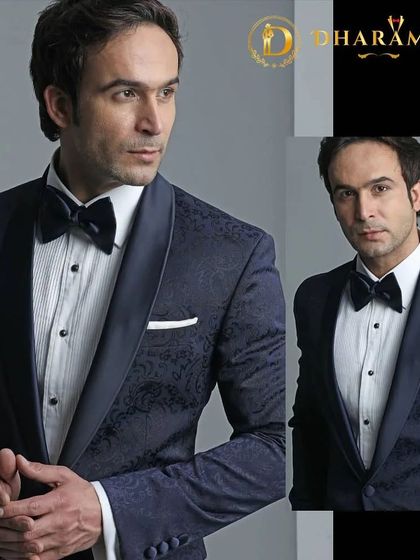 A model in a navy blue tuxedo with a subtle pattern on the jacket. The fit is impeccable, showcasing the sharp lines of bespoke tailoring.