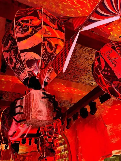 Custom-printed hot air balloon lanterns with skull motifs hanging from the ceiling.
