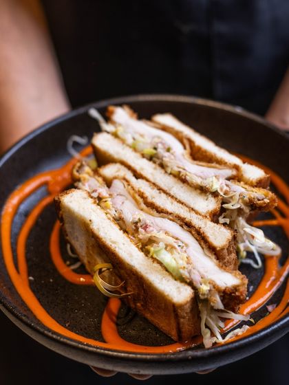 Come try the iconic Buttermilk Fried Chicken sandwich. It's crispy, juicy, and served with a tangy slaw.