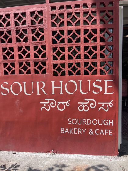 A closer look at the hand-painted typography for Sour House. The clean, crisp lettering adds a professional yet personal touch to the cafe's exterior.