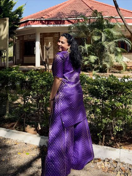 A stunning purple brocade suit, perfect for a Sangeet or reception. The rich color and traditional fabric make a bold statement on stage.