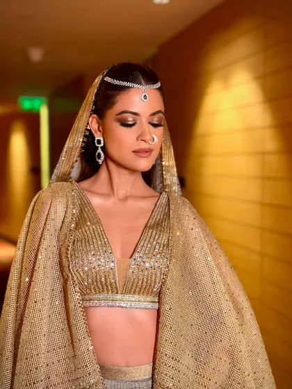 This shot captures the movement and shimmer of the outfit and makeup. It’s a look designed for a bride who wants to feel like a modern goddess on her special day.