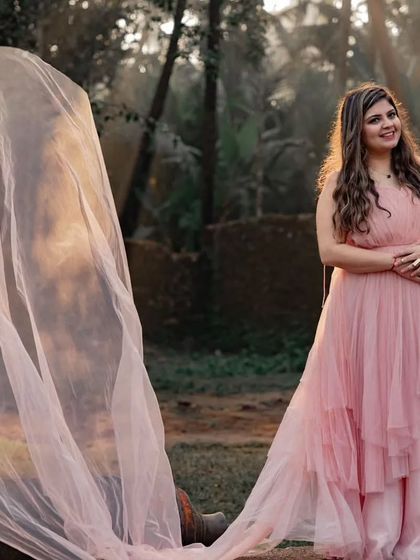 The soft peach color of this net trail gown gives it a romantic, sunset feel. The lightweight fabric is easy to work with and creates beautiful, airy shapes.