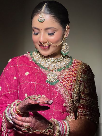 A happy bride admiring her complete look. The radiant skin and soft glam makeup created a dreamy and ethereal vibe for her special day.