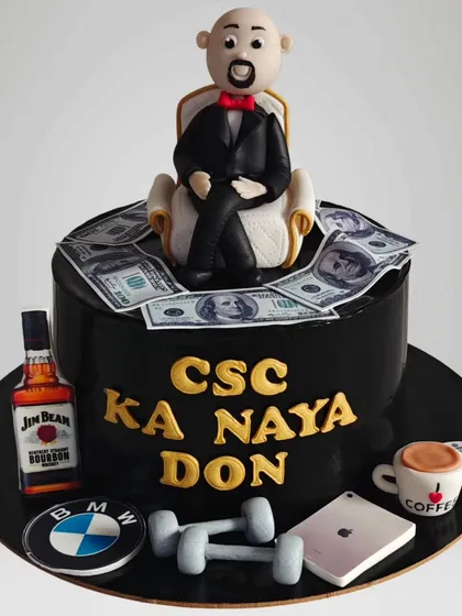 A fun "Naya Don" cake for a celebration of success. This cake features a fondant figure, edible money, and icons of luxury like a BMW logo and Jim Beam bottle.