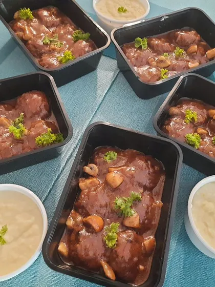 This is my Salisbury Steak, a classic comfort dish. I make juicy meat patties and simmer them in a delicious mushroom sauce, served alongside a generous portion of creamy mashed potatoes.