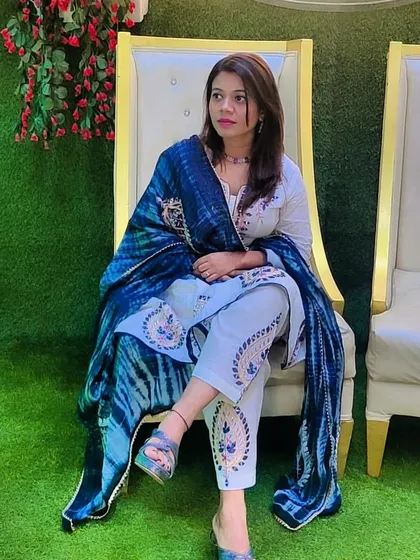 A photo of me in a beautiful ethnic outfit at a wedding. I love dressing up for Indian functions and celebrating with my clients.