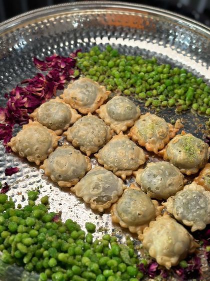 Lilva Ghugras, a traditional Gujarati pastry filled with fresh green peas. This savoury treat, often made during winter, is a delightful addition to any festive menu.