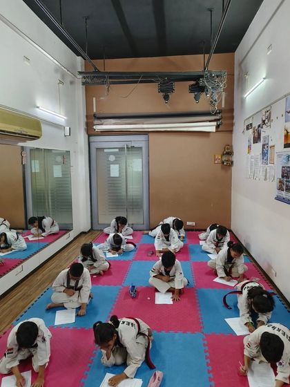 Students are focused during their written examination for belt promotion. I believe a true martial artist must understand the 'why' behind the 'how', and this test ensures they do.