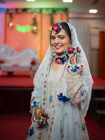 A happy portrait of the bride at her Mehendi ceremony. Her bright smile and beautiful attire perfectly capture the festive spirit of the event.
