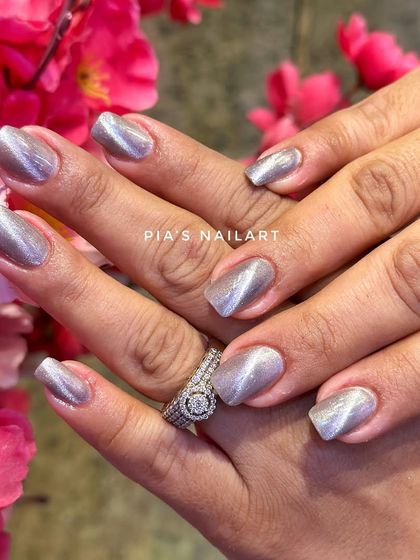 If you've never tried cat eye nails, this is your sign. This silver magnetic polish gives a simple, sophisticated, and shimmery look.