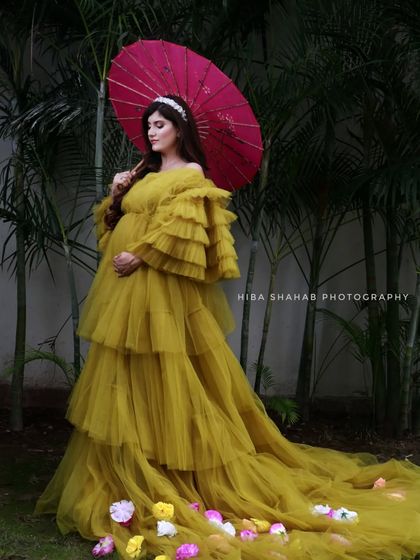This mustard yellow ruffled gown, paired with a traditional red parasol, creates a unique and culturally rich look. My gowns can be styled to reflect your personal heritage and taste.