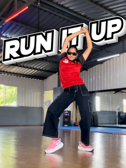 A powerful pose from our "Run It Up" choreography. This shot shows the dynamic shapes and strong lines we teach in our hip-hop dance classes.