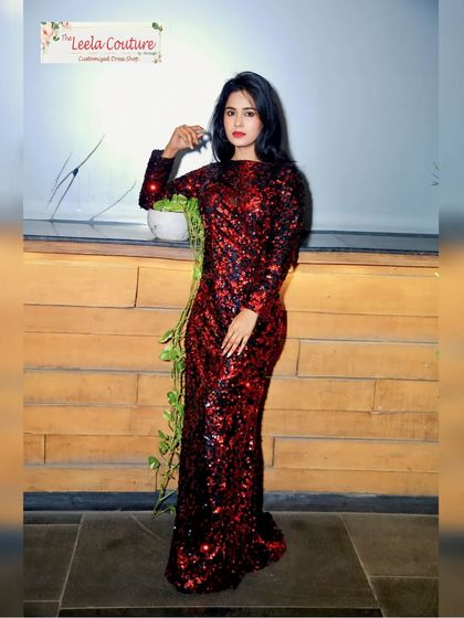 A full front view of the red and black sequin gown. The way the sequins are placed creates a beautiful texture and shine from every angle.