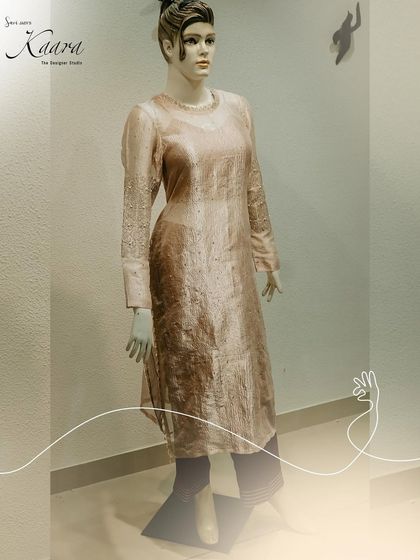 A full view of our shimmering net kurti set on a mannequin. This outfit is perfect for an elegant evening event, offering a sophisticated silhouette with a touch of sparkle.