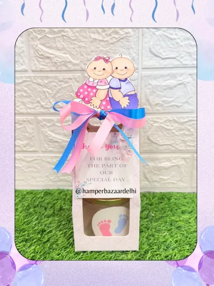 A simple and sweet baby announcement hamper in a cardboard bag, an affordable and charming option.