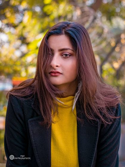 A close-up from the same session, focusing on the model's expressive eyes and the soft, natural light.