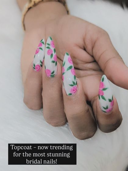 A closer look at the stunning floral bridal nails. The text overlay emphasizes that we are trending for creating beautiful and unique designs for brides.