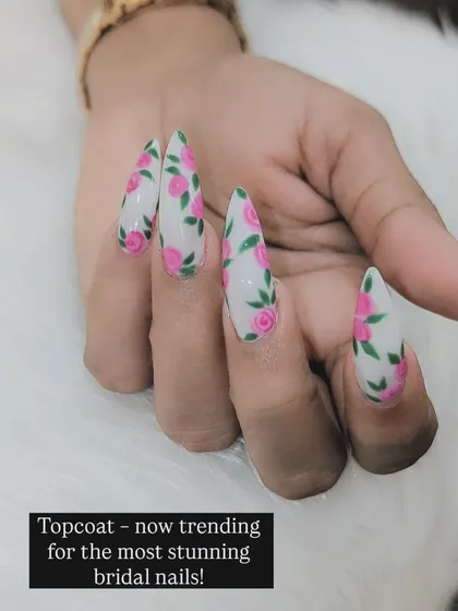 A closer look at the stunning floral bridal nails. The text overlay emphasizes that we are trending for creating beautiful and unique designs for brides.