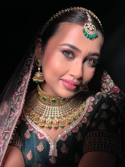 The drama of light and shadow. This image captures the depth of the eye makeup and the radiance of the skin.