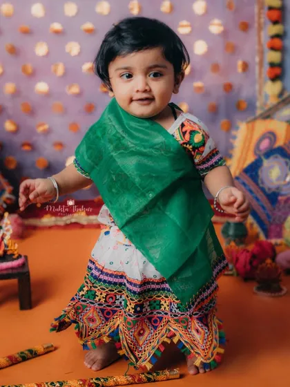 Posing with her dandiya sticks, this little one is the star of our Garba-themed photoshoot.