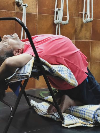 A supported backbend on a chair.