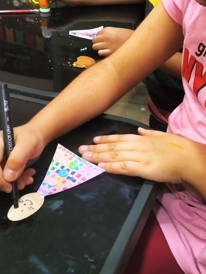 A close up shot of little hands at work. Crafting activities like this help develop fine motor skills, concentration, and attention to detail in a fun, hands on way.