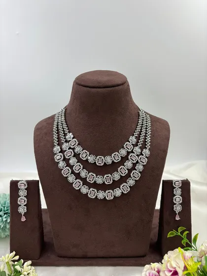 The three-layer AD necklace with pink stones.