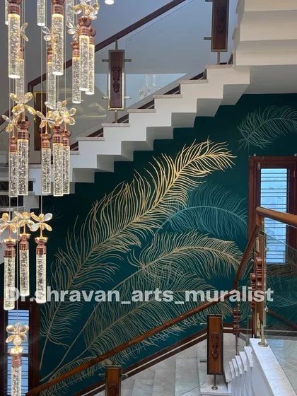 This double-height staircase wall was transformed with delicate, hand-laid gold foil feathers over a deep teal background. The way the metallic finish catches the light as you walk by creates a dynamic and luxurious experience, turning a simple wall into a statement piece.