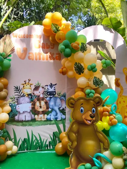 The full view of our jungle welcome party setup. The combination of the custom backdrop, character cutouts, and a lush balloon garland creates a complete and immersive safari experience.