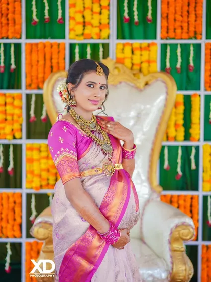 A classic portrait of the mother-to-be, beautifully adorned in traditional jewelry and attire for her special day.