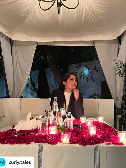 A guest enjoying her beautifully decorated table, a candid moment captured from a feature by Curly Tales.