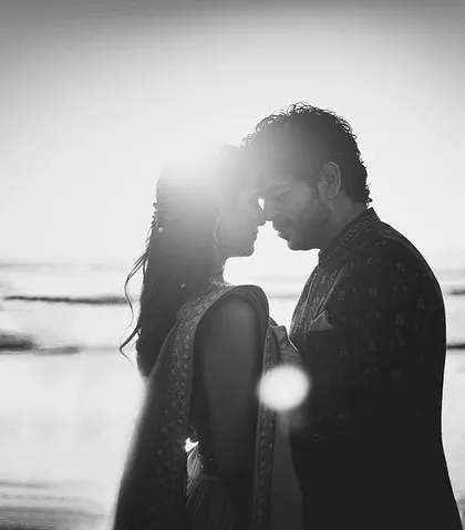 The same sunset silhouette in black and white, offering a different mood. It feels classic, dramatic, and profoundly romantic.