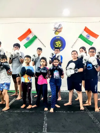 A team of young boxers ready to train. We teach them to stand strong, keep their guard up, and work together. The discipline of boxing builds character both inside and outside the gym.