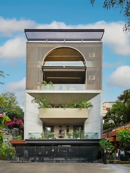 This project in Gurugram features a classical facade adorned with sophisticated grey and white tones alongside opulent gold aluminum louvers. This design redefines luxury and elevates the living space to new heights.