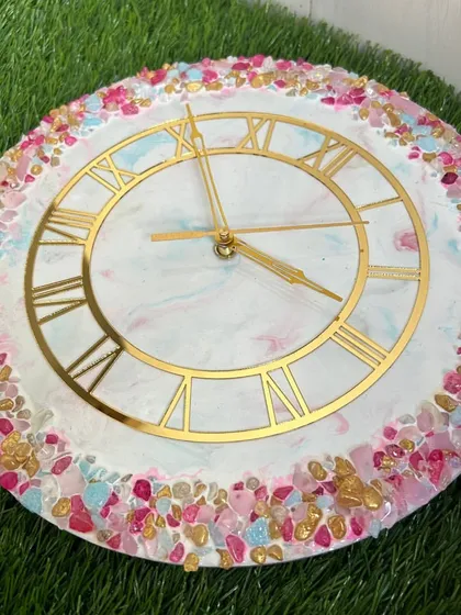 A vibrant and colorful clock with a multi-colored crystal border in shades of pink, blue, and gold.