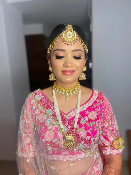 A close-up of Pooja's makeup, highlighting the flawless application and the beautiful pink tones on her eyes and lips.