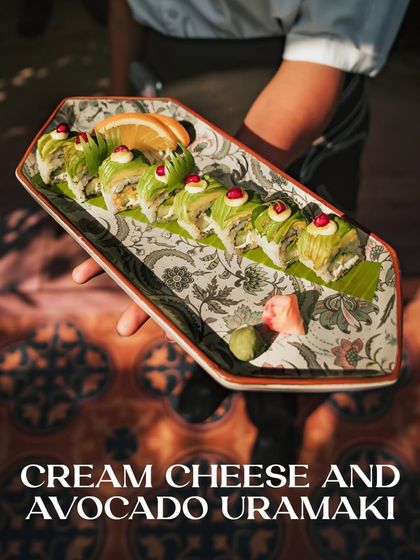 Cream Cheese and Avocado Uramaki, an "inside-out" roll that is both rich and refreshing, topped with vibrant tobiko.