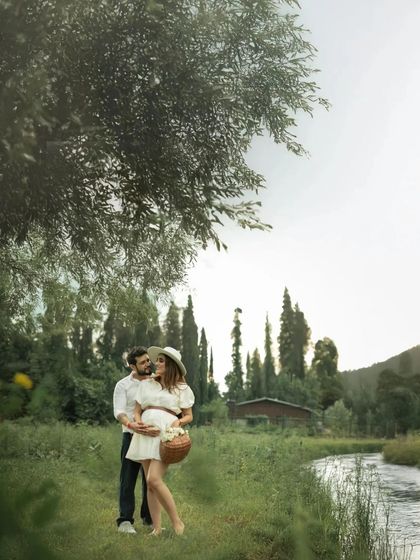 An embrace filled with love and tenderness, set in a beautiful riverside location. The natural framing from the tree above adds depth to this romantic couple portrait.