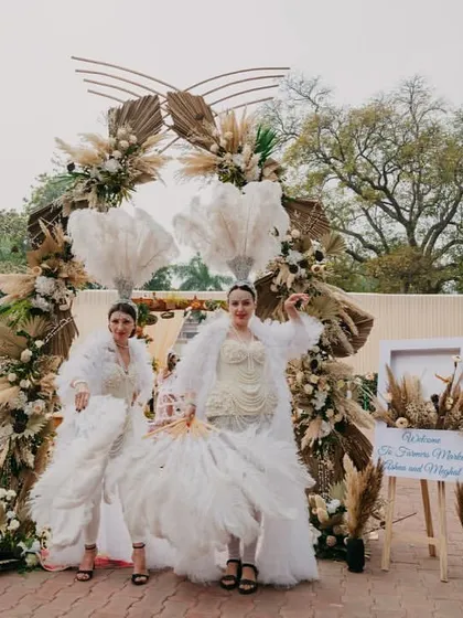 Performers in ethereal white costumes welcome guests, perfectly matching the rustic and dreamy decor.