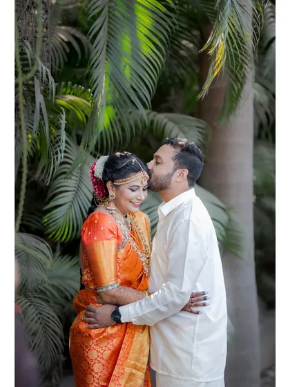 A romantic moment with the groom kissing his bride's forehead, a timeless expression of love and affection.