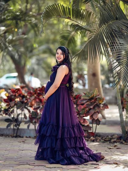 This full-length shot shows the beautiful tiered ruffles on our purple maternity gown. It adds volume and a princess-like feel, perfect for making a statement.