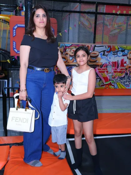 A mother and her children take a break from the action to pose for a photo in our trampoline park. It's a space for fun for the whole family.