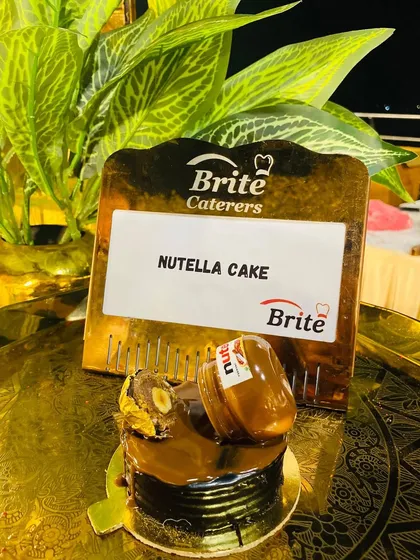 An individual Nutella cake, creatively topped with a miniature Nutella jar, a treat for all chocolate lovers.