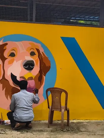 The artist brings the mural to life with vibrant colors. This painting of our founding dog, Kavya, is becoming the new heart of our visual identity at the sanctuary.