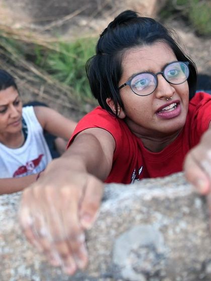 This close-up captures the intensity and determination of a climber topping out.