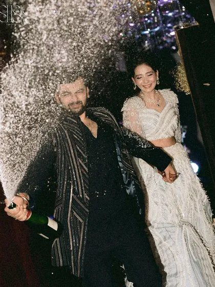 This is the energy we live for. A sangeet night isn't just about dance, it's about pure, unadulterated joy. Capturing this exact moment of a champagne pop, with the couple's ecstatic expressions, shows our ability to freeze high-energy moments and turn them into timeless memories of celebration.