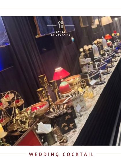 A beautifully arranged buffet for a wedding cocktail party. The setup features elegant decor with red accents and a variety of dishes to suit every palate.