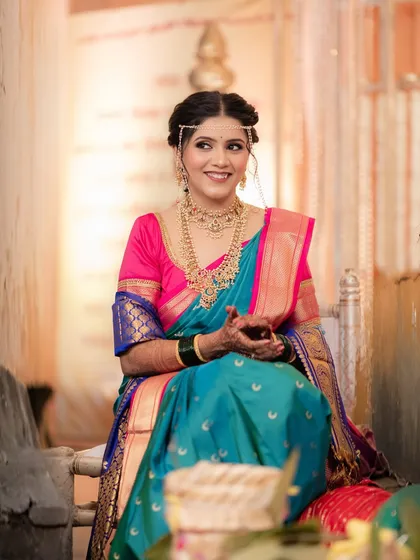 A candid smile from our lovely South Indian bride. Her makeup is fresh and radiant, designed to look beautiful in both natural and indoor lighting.