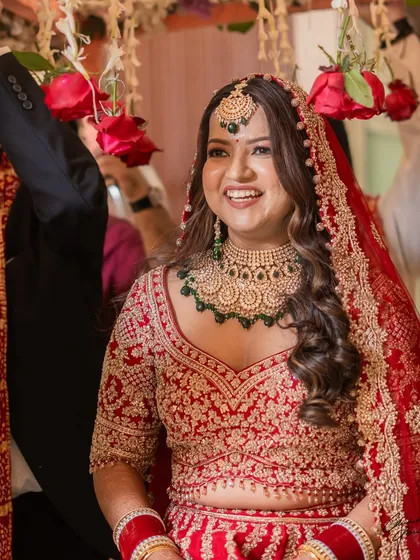 The grand entrance. This bride looks absolutely radiant as she walks in, her red lehenga and flawless makeup making her the center of attention.